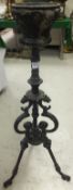 A Victorian Gothic revival cast iron tripod torchere