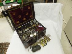 A 19th Century rosewood and brass inlaid dressing table box containing various cut glass bottles and