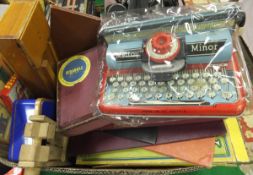 A box of various vintage toys including Mattoy Minor typewriter, vintage Scrabble, Peg'ity, Rubik'