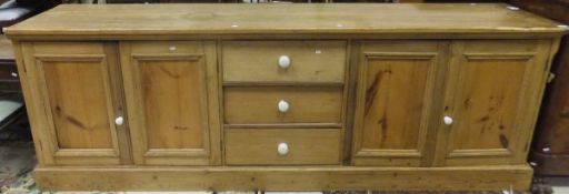 A large pine dresser with three central drawers flanked by two cupboard doors   CONDITION REPORTS