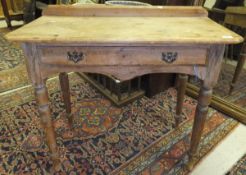 A late 19th / early 20th Century pine washstand / side table with single frieze drawer, raised on