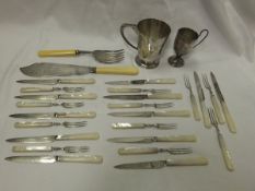 A set of eleven silver fruit knives and forks mounted with mother of pearl handles (Sheffield,