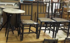 Three bobbin turned cane seated side chairs and two circular Gypsy style tables with black painted