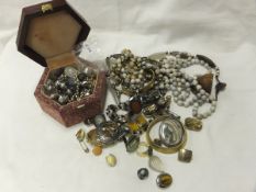 A box containing assorted costume jewellery to include rings, beaded necklaces, earrings, etc and