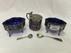 A pair of late 18th Century silver salts with pierced decoration raised on four padded feet with