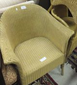 A cream painted Lloyd Loom chair