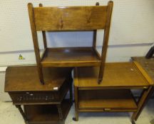 A reproduction oak credence style table with single frieze drawer and two oak two tier tea trolleys