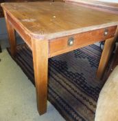 A small rectangular pine kitchen table with single end drawer with brass ring handles