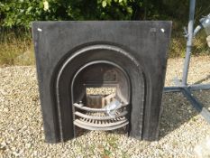 A cast iron fire surround with integral basket