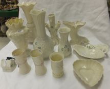 A large collection of Belleek porcelain to include vases, heart shaped dish, Art Nouveau style