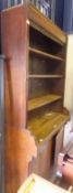 A Victorian oak bookcase cabinet with open adjustable shelving over two cupboard doors