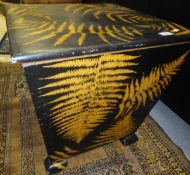 A black painted box with fern decoration and lift-up lid