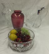 A ruby ground coloured glass vase with iridescent finish, a Dartington crystal clear glass vase, a