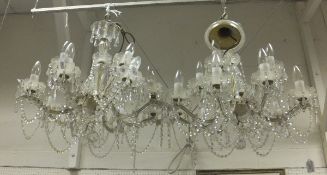 A pair of eight branch glass, brass and hanging lustre electroliers