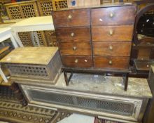 A pine chest of eight drawers with brass handles on stand, together with a marble topped radiator