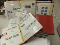 A box containing various stamp albums containing assorted First Day Covers, loose stamps, etc