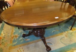 A Victorian mahogany breakfast table, the oval snap top on a turned pedestal to cabriole tripod base