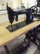 A Singer sewing machine, bearing No's 31K15 and EC29829, raised on a wooden topped treadle base,