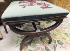 A Victorian rosewood X shaped stool with needlework top