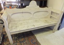 A white painted pine bench with shaped back