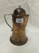 A Birmingham Guild Limited brass and copper hot water pot of flared form in the style of Arthur