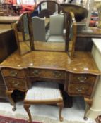 An early to mid 20th Century burr walnut veneered dressing table with similar triple dressing mirror