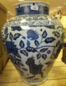 A modern Chinese octagonal baluster shaped vase with exotic bird panel decoration