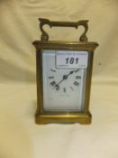 A French brass five glass carriage clock, the white enamel dial set with Roman numerals inscribed "