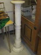 A turned alabaster column with plinth top