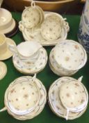 A Coalport tea service to include ten teacups, assorted side plates, bowls and plates, cream jug and