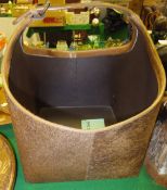 A hide covered basket style wastepaper bin