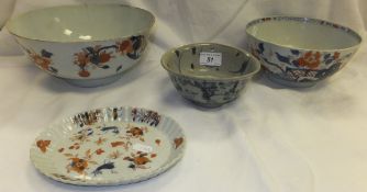 A Chinese bowl decorated with blue swirled pattern on footed base, two Imari bowls and an oval dish