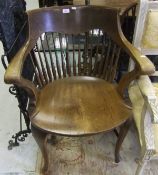 A circa 1900 oak comb back office chair