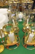 Three pairs of brass bodied candle holders with clear glass shades