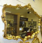 A modern Rococo style gilt framed wall mirror