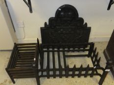 A cast iron fire back with crown and fleur de lys decoration together with two cast iron fire