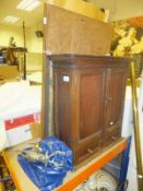 An oak wall cabinet of two doors above two cupboard doors, together with a cast metal figure of a