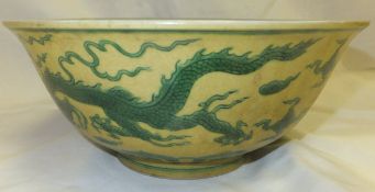 A famille-jeune bowl decorated on a yellow ground with green dragon chasing pearl decoration with