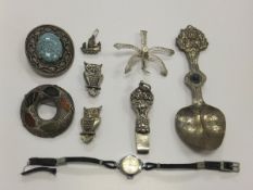A collection of jewellery to include various white metal and stone set brooches, a white metal and