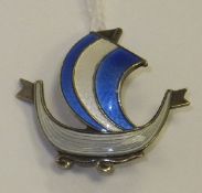 An enamelled brooch in the form of a Norwegian sailboat, stamped "Norway Sterling 925S" to back