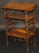 A Liberty & Co. oak reading table designed by Leonard Wyburd, the sloping top above two shelves with