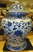 A blue and white Oriental style baluster shaped vase and cover