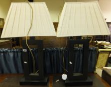 A pair of modern anodised steel table lamps with cream pleated shades