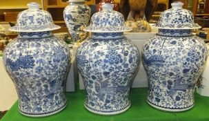 Three modern blue and white Chinese style baluster shaped vases and covers bearing inscription to