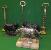 Three brass door porters, two cast iron doorstops in the form of rams and a white metal figure of