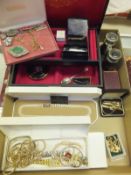 A box containing assorted costume jewellery to include various brooches, necklaces, cufflinks, etc