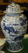 A Chinese blue and white baluster shaped vase and cover with kylin and ball decoration