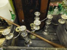 A pair of electro-plate three branch candelabra, a pair of brass candlesticks, a copper and brass