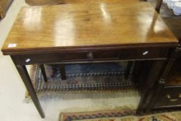 A 19th Century mahogany tea table, the rectangular fold-over top above a single drawer on square