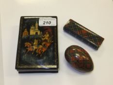 A 20th Century signed Russian lacquered box with hinged lid, together with a tartan ware egg in